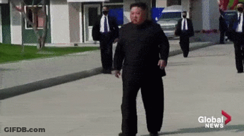 Man In Suit Walking Past Global News Logo GIF