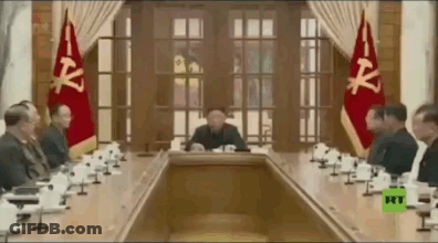 Man In Suit Walking Past Global News Logo GIF
