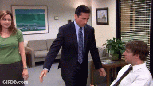 Man In Suit Walking Past Woman And Man In White Shirt GIF