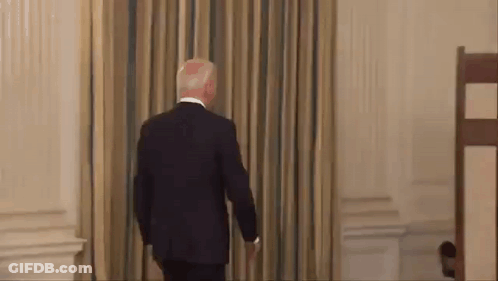 Man In Suit Walking Through Doorway GIF