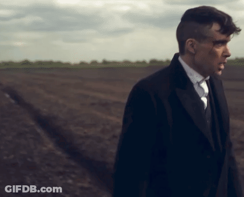 Man In Suit Walking Through Field GIF