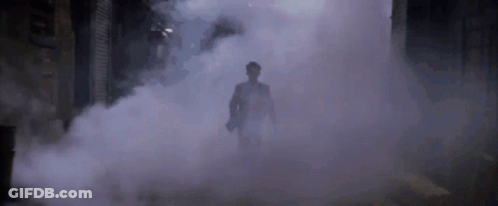 Man In Suit Walking Through Foggy Tunnel GIF