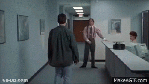 Man In Suit Walking Toward Counter GIF