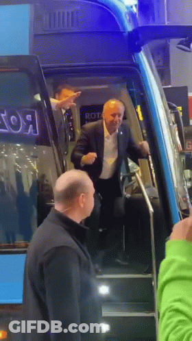 Man In Suit Walking Up Bus Stairs With Rot GIF