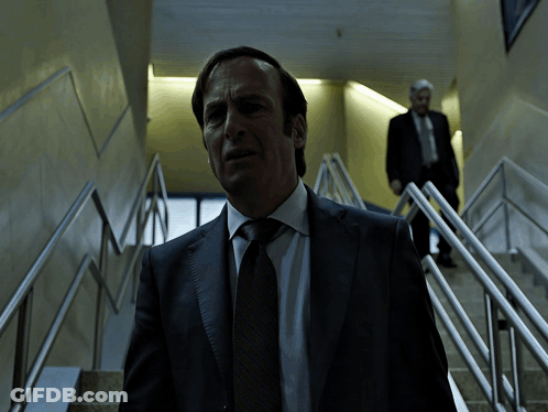 Man In Suit Walking Up Stairs GIF