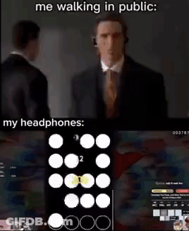 Man In Suit Walking With Headphones GIF