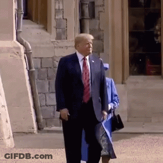 Man In Suit Walking With Woman In Blue Coat GIF