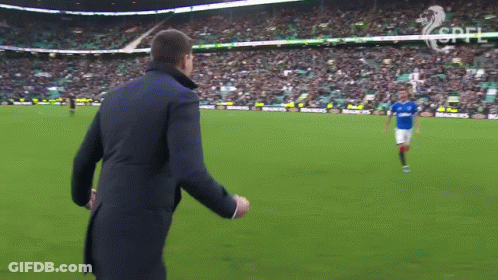Man In Suit Watching Soccer Player In Blue GIF