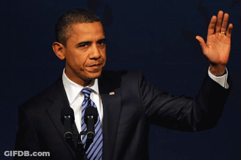 Man In Suit Waving At Two Microphones GIF