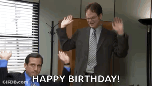 Man In Suit Waving Hands While Another Says Happy Birthday GIF
