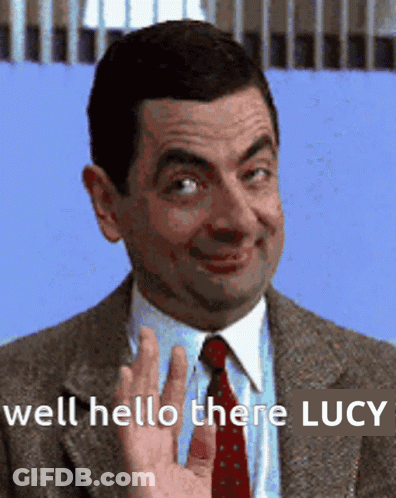 Man In Suit Waving Hello There Lucy GIF