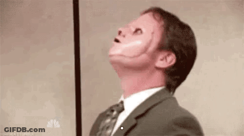 Man In Suit Wearing Fake Face GIF
