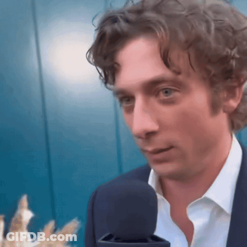 Man In Suit White Shirt Talking Into Microphone GIF