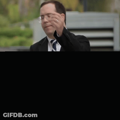 Man In Suit Wiping Face GIF
