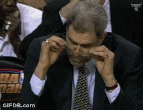Man In Suit Wiping Nose GIF