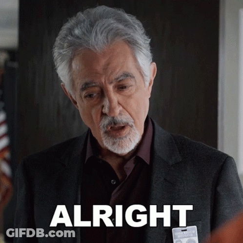 Man In Suit With Alright Badge GIF