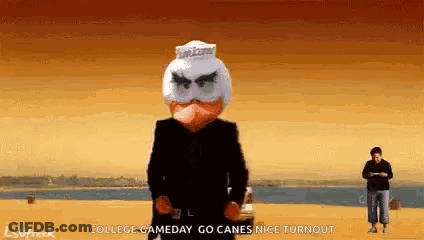 Man In Suit With Angry Bird Mask In Front Of Car GIF