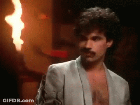 Man In Suit With Aqua Shirt In Front Of Crowd GIF