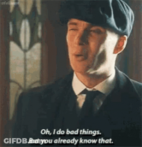 Man In Suit With Arms Crossed In Front Of Red Curtain GIF