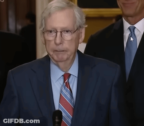 Man In Suit With Arrow Pointing To Tie GIF