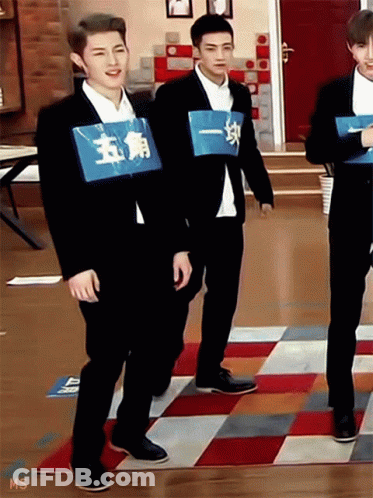 Man In Suit With Blue Sign Saying 五角 GIF