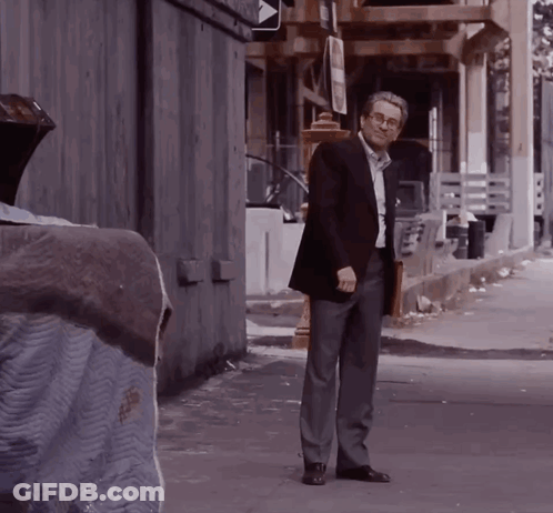 Man In Suit With Briefcase In Alleyway GIF