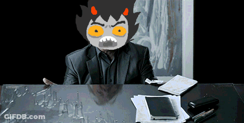 Man In Suit With Cartoon Face At Desk GIF