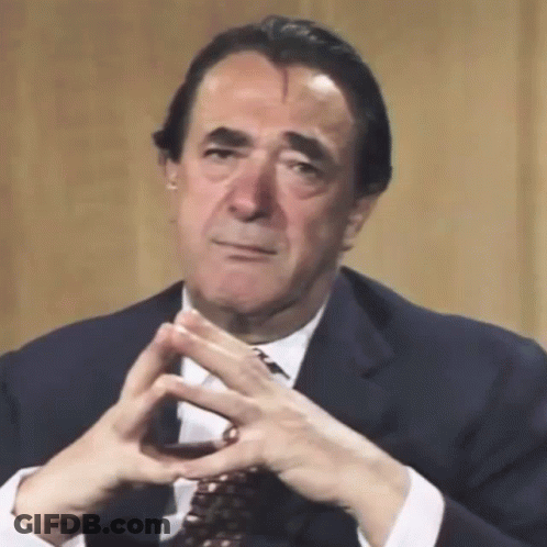 Man In Suit With Folded Hands GIF