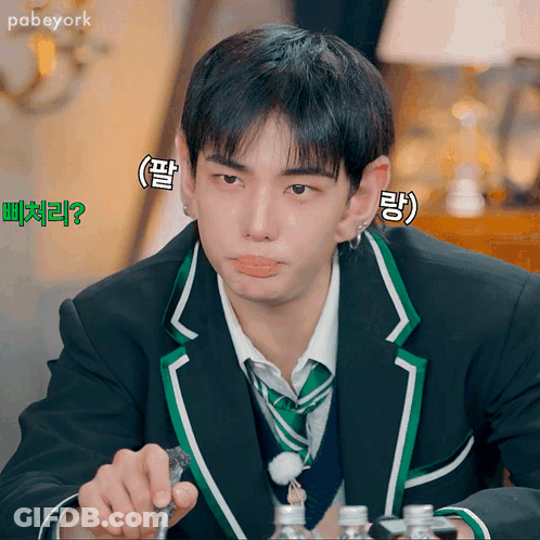 Man In Suit With Foreign Writing On Face Eating GIF