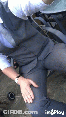 Man In Suit With Hands On Hips And Watch GIF