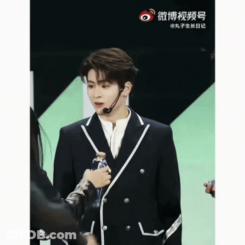 Man In Suit With Headset Microphone Next To Woman GIF