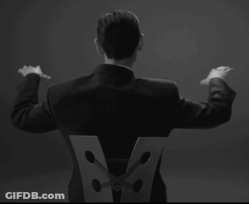 Man In Suit With Letter V On Back GIF