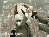 Man In Suit With Mascot On Head Shaking Hands GIF