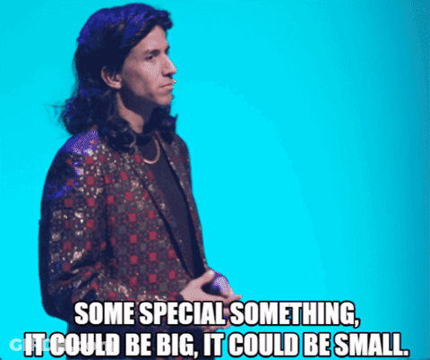 Man In Suit With Microphone Saying It Could Be Big And Small GIF