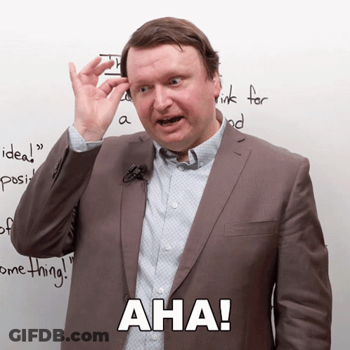 Man In Suit With Microphone Says Aha GIF