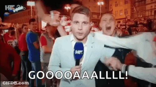 Man In Suit With Microphone Yells Goooooaaalll GIF