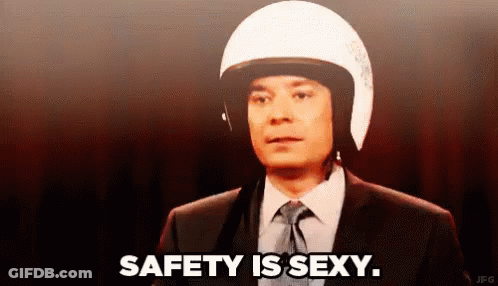 Man In Suit With Motorcycle Helmet Says Safety Is Sexy GIF