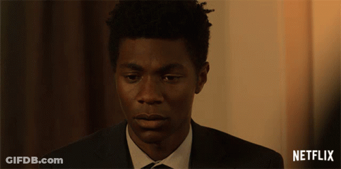 Man In Suit With Netflix Logo GIF