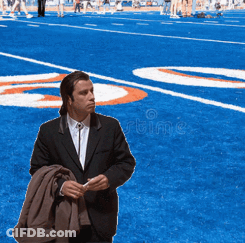 Man In Suit With Number 20 On Football Field GIF