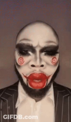 Man In Suit With Painted Puppet Face GIF