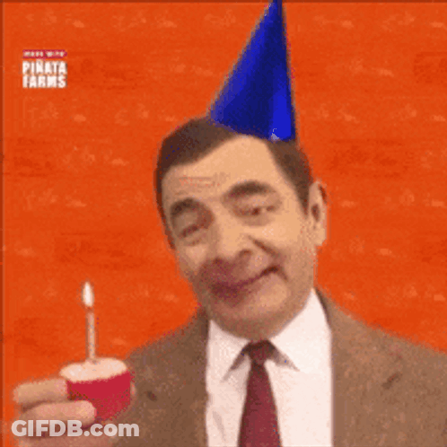Man In Suit With Party Hat Holding Cupcake GIF
