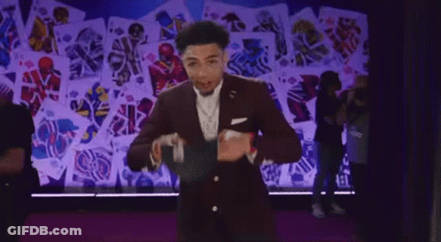 Man In Suit With Playing Cards On Wall GIF