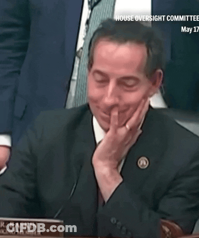Man In Suit With R.J. Raskin Nameplate GIF