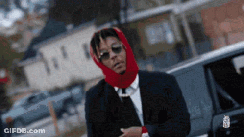 Man In Suit With Red Scarf On Head GIF