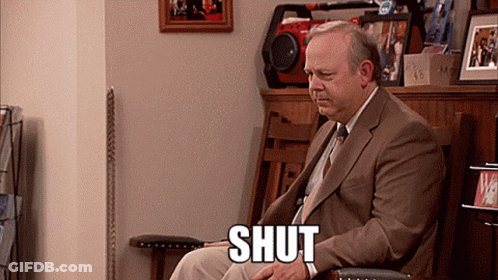 Man In Suit With Shut On Lap GIF