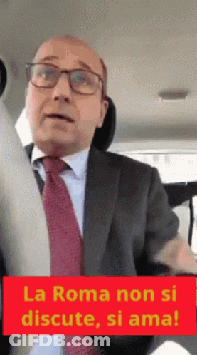 Man In Suit With Sign La Roma Non Si Discute Si Ama GIF