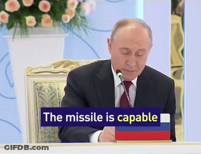 Man In Suit With Sign Missile Is Capable GIF
