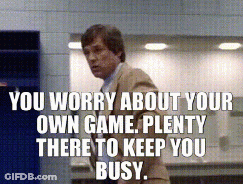 Man In Suit With Sign You Worry About Your Own Game GIF