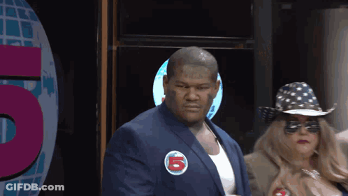 Man In Suit With Sticker Saying 5 GIF