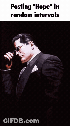 Man In Suit With Superman Emblem GIF